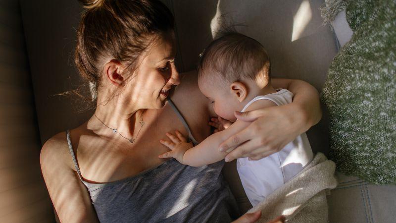 Mother and baby cuddling in bed